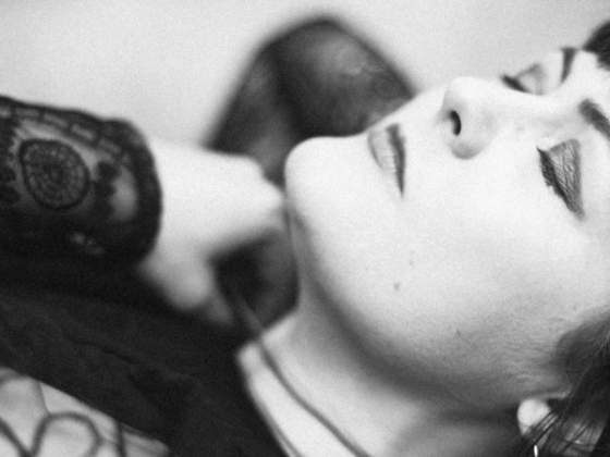 Singer-songwriter Austel pictured lying down with her eyes closed, in black and white