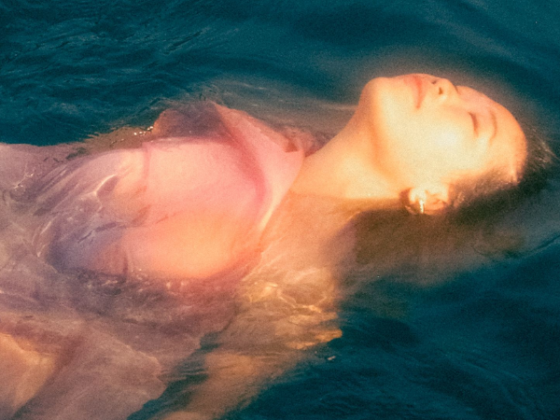 Artist Linying floats in a pool of water with a hazy filter as the artwork for her upcoming album